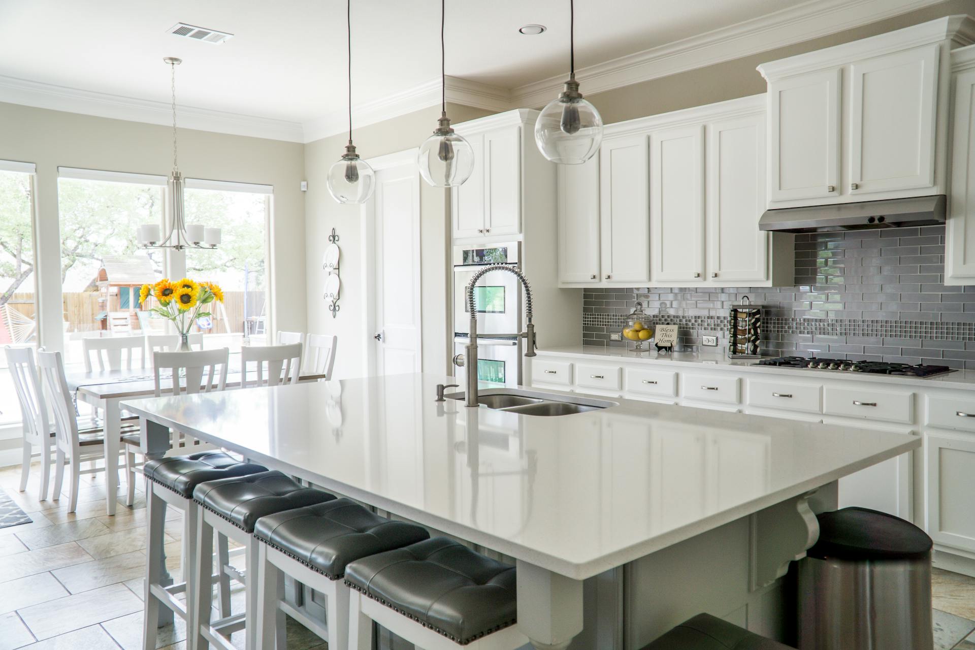Modern renovated kitchen with white cabinets and stainless steel appliances